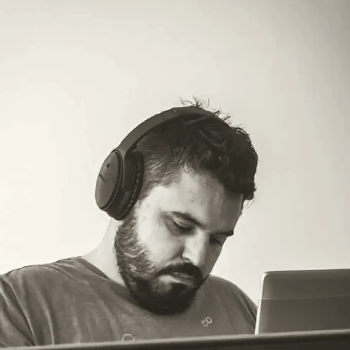 Aleksandar Perisic at his desk, headphones on, mid-build.